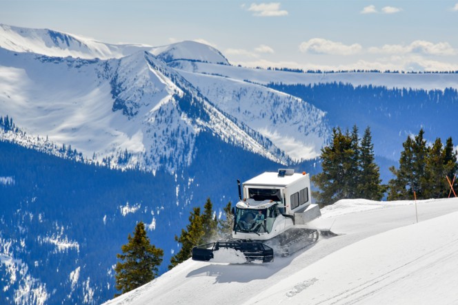 Snow cat driving up a mountain in Colorado.